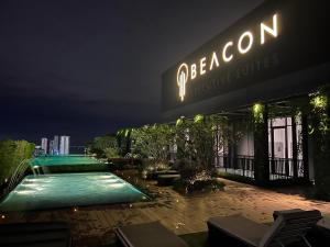 a restaurant with a swimming pool at night at Georgetown#Beacon Executive Suite SkyPool#Modern & Elegant Suite# in George Town
