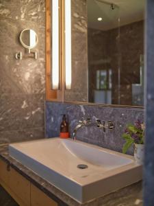 a bathroom with a sink and a mirror at Alpine Chalet Apartment With Zugspitze Views in Grainau
