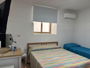 a bedroom with a bed and a window at B&B IL GIRASOLE in Maddaloni
