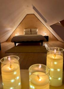 a room with a bed with candles on a table at Le Nid de Schatzi in Haguenau