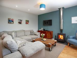 una sala de estar con un sofá y una chimenea en Semybadazee, en Poundstock