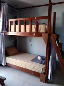 twolevel bunk beds in a room with at Ning Ning hostel Dondet in Don Det