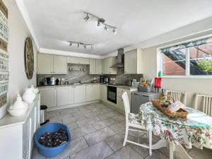 a kitchen with a table and chairs in a room at Broadoak Barn in Ellesmere
