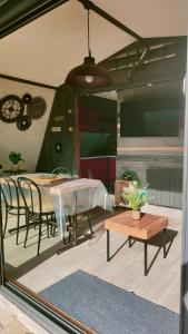 a patio with a table and chairs and a table at Chalet de détente in Métabief