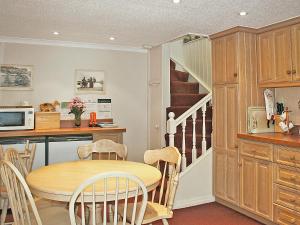 a kitchen and dining room with a table and chairs at Flagstaff Cottage in Robin Hood's Bay