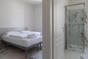 a bedroom with a bed and a glass shower at Astoria Guest House in Ravenna +37 photos