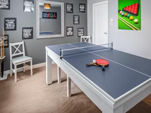 a ping pong table in a room with a chair at The Ascot in Blackpool
