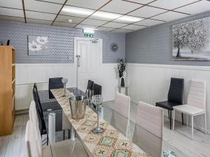 a dining room with a glass table and chairs at The Ascot in Blackpool