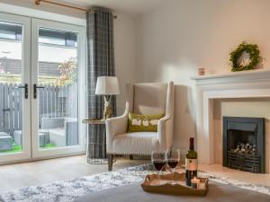 a living room with a chair and a fireplace at Dales Retreat in Skipton