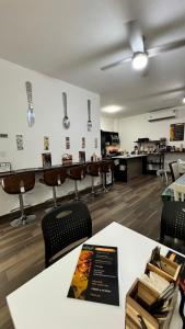 a room with a table and chairs in a kitchen at Hotel Cuatro Palmas in Puerto Peñasco +24 photos