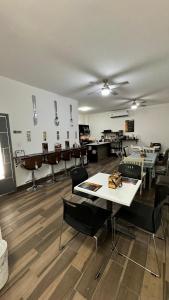 a room with tables and chairs in a room at Hotel Cuatro Palmas in Puerto Peñasco