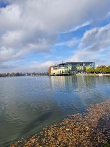 a building on the shore of a body of water at Un spa privatif à 20 minutes de paris in Épinay-sur-Seine