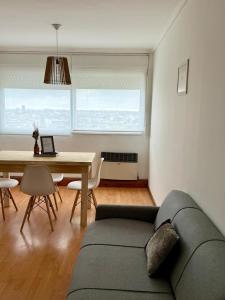 a living room with a couch and a table at Departamento Impecable Luminoso! in Azul