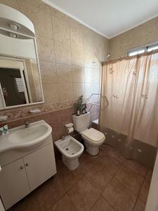 a bathroom with a sink and a toilet and a shower at Departamento Impecable Luminoso! in Azul