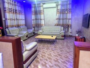 a living room with couches and a coffee table at Cape Villa in Arusha