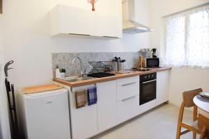 a kitchen with white cabinets and a sink at La Manutention in Saumur
