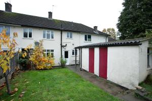 una casa bianca con un garage rosso e bianco di 4 Bed Contractor Accommodation in Longbridge a Longbridge