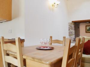 a dining room table with wine glasses on it at Barn Owl Cottage in Cromford