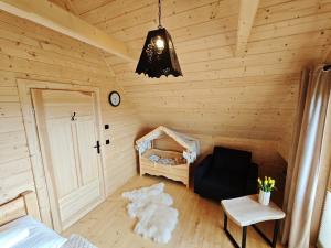 a room in a wooden cabin with a bedroom at Domek z Sercem in Pieniążkowice +9 photos