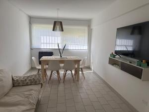 a living room with a table and a couch at Departamento impecable! in Azul