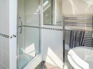 a bathroom with a glass shower and a toilet at The Old Laundry 3 in Keswick