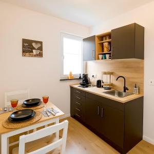 a kitchen with a table and a sink and a counter at Wohnung in Siegen in Wilnsdorf