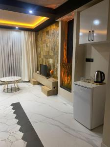 a room with a kitchen with a stove and a tv at paradise hotel in Istanbul