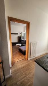 a room with a living room with a couch and a mirror at Ruhiger Flussblick vom Balkon in Niederdorla +7 photos