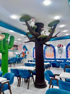 a restaurant with a tree with birds on it at Baku Center inn NS in Baku