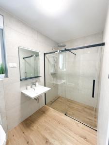 a bathroom with a glass shower and a sink at Roza in Primošten +33 photos