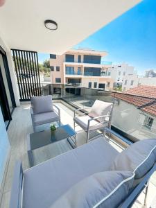 a patio with two chairs and a table on a balcony at Roza in Primošten