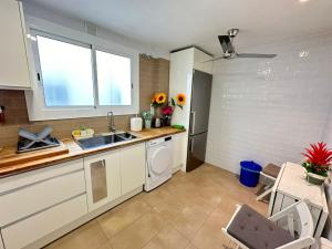 a kitchen with a sink and a dishwasher at Rooms Borrells in Barcelona +24 photos