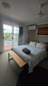 a bedroom with a large bed and a large window at Terrace River House in Caddys Island