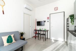 a living room with a couch and a table at Baroni C - FREE private parking-wi- fi and A-C in Gerenzano