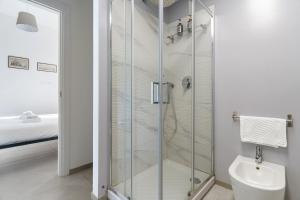 a glass shower in a bathroom with a toilet at Baroni C - FREE private parking-wi- fi and A-C in Gerenzano +16 photos