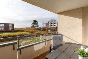 a balcony with a table and a view of a building at Haus Uthlande Uthlande Whg 3 Strandliebe in Wyk auf Föhr