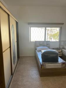 a bedroom with a bed and a window at 2 Bedroom apartment in Jerash Centre in Jerash