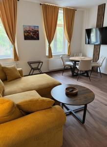 a living room with a couch and a table at Samaya Apartment in Litoměřice