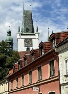 a building with a clock tower on top of it at Samaya Apartment in Litoměřice