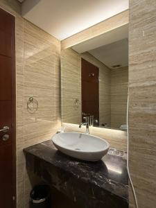 a bathroom with a sink and a large mirror at Panbil Residence Apartment Lvl 15 with Forest View in Kangboi
