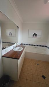 a bathroom with a sink and a bath tub at Terrace River House in Caddys Island