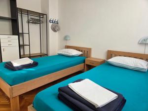 two beds in a room with blue sheets at Gumla House in Stara Novalja +66 photos