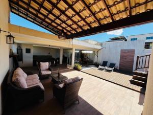 a living room with a patio with a pool table at CasaMare in Cariacica