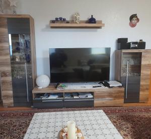 a living room with a large flat screen tv at Ferienwohnung Monika Staßfurt OT Üllnitz an der A14 in Glöthe