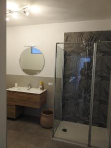 a bathroom with a shower and a sink and a mirror at B&B Stella d'Oro in Vezzano +8 photos