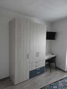 a bedroom with a large cabinet and a desk at B&B Stella d'Oro in Vezzano
