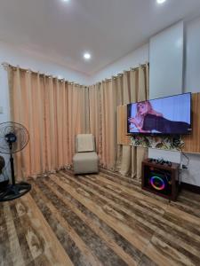 SungayTwin Sister House Tagaytay Private Pool的配有平板电视和椅子的客厅
