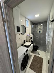 a bathroom with a toilet and a sink and a shower at Lux Stay Apartmant in Varaždin