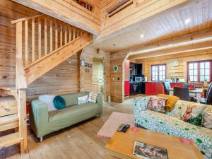 a log cabin living room with a couch and a table at Ty Afal - Uk42099 in Carno