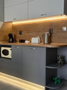 a kitchen with white cabinets and a counter top at Cozy studio near the park with huge verandah. in Veliko Tŭrnovo